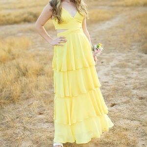 Stunning yellow tiered cut-out prom dress.